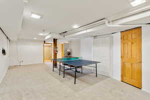 Rec room featuring baseboards and light colored carpet