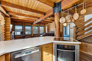 Kitchen with light countertops, track lighting, oven, dishwasher, and black electric cooktop