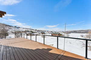 Snow covered deck with a mountain view