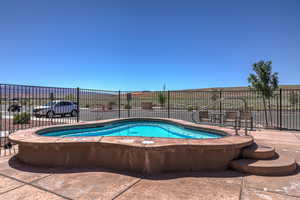 View of swimming pool with fence and a pool