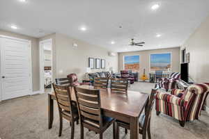 Dining area with recessed lighting, light colored carpet, and a textured ceiling