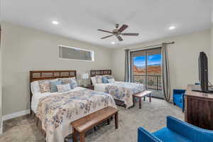 Bedroom with ceiling fan, recessed lighting, light colored carpet, baseboards, and access to outside