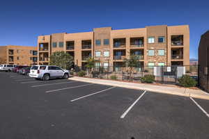 View of property with uncovered parking and fence