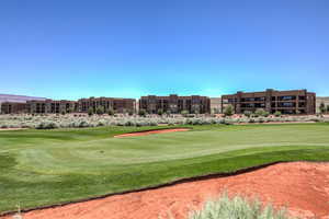 Surrounding community with a yard and golf course view