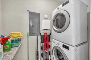 Laundry area with stacked washer and dryer, laundry area, and electric panel