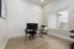 Office featuring light wood-type flooring, baseboards, and recessed lighting