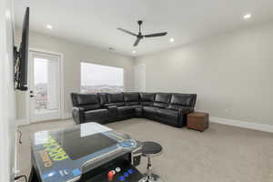 Living room featuring light carpet, baseboards, and recessed lighting