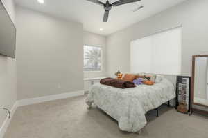 Bedroom with baseboards, visible vents, light colored carpet, and recessed lighting