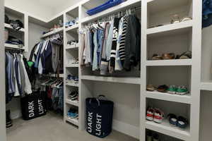 Walk in closet with carpet flooring