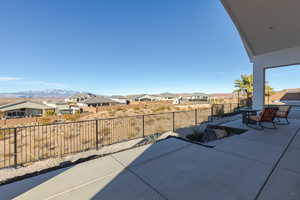 View of patio / terrace with a residential view, a fenced backyard, and a mountain view