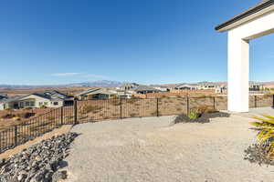 View of yard featuring a mountain view, a fenced backyard, and a residential view