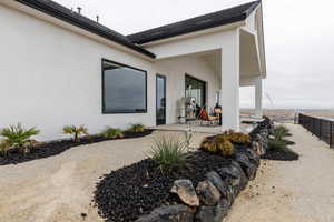 Exterior space with a patio area, fence, and stucco siding