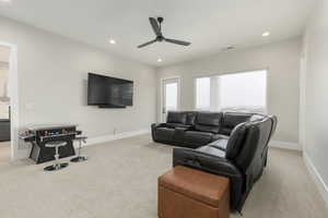 Living area featuring recessed lighting, visible vents, light carpet, and baseboards