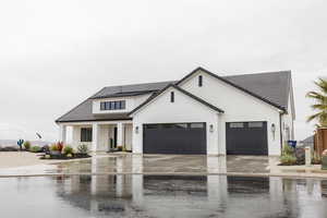 Modern farmhouse style home featuring concrete driveway, an attached garage, a tiled roof, and stucco siding