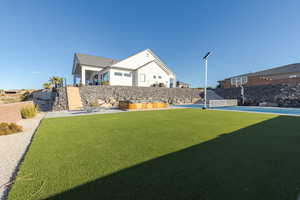 View of yard with fence and basketball court