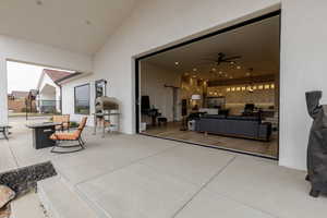 View of patio featuring fence and ceiling fan