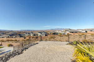 View of yard with a residential view, a mountain view, and fence