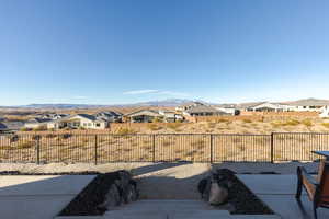 View of yard featuring a residential view, a patio area, a fenced backyard, and a mountain view