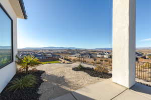 View of patio featuring fence, a mountain view, and a residential view