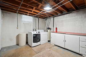 Washroom with washer and dryer and cabinet space