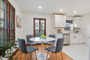 Dining space featuring marble finish floor, visible vents, french doors, and recessed lighting