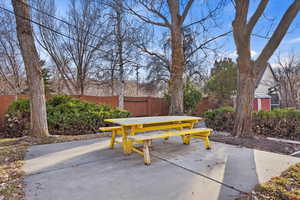 View of patio with outdoor dining space and fence