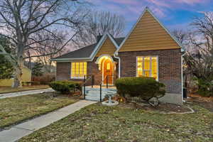 View of front facade featuring brick siding and a front lawn