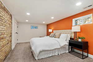 Carpeted bedroom with baseboards, multiple windows, visible vents, and recessed lighting