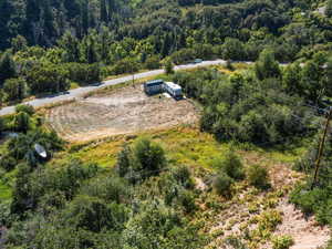 Birds eye view of property featuring a view of trees