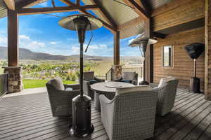 Deck featuring a mountain view and outdoor dining space