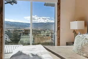 Bedroom with multiple windows and a mountain view