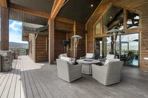 Wooden terrace featuring an outdoor living space and a mountain view