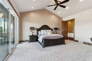 Bedroom featuring lofted ceiling, baseboards, visible vents, and light colored carpet