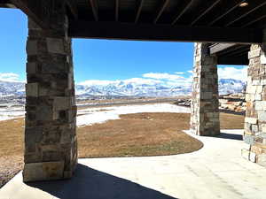 Snow covered patio with a mountain view