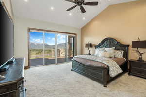 Bedroom with high vaulted ceiling, a mountain view, recessed lighting, light carpet, and access to outside