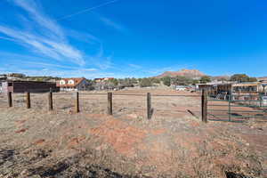 View of yard featuring a mountain view and fence