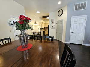 Dining room with baseboards, visible vents, dark wood finished floors, and recessed lighting