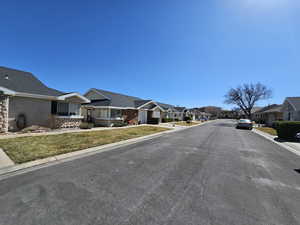 View of street with sidewalks, a residential view, and curbs