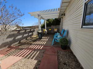 View of patio with a fenced backyard and a pergola