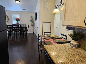 Dining space featuring baseboards, visible vents, and dark wood-style flooring