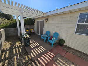 View of patio with a fenced backyard and a pergola