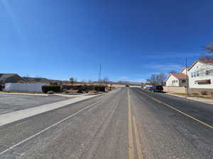 View of road featuring a residential view, curbs, and sidewalks