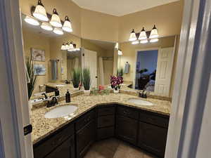 Ensuite bathroom featuring visible vents, ensuite bath, vanity, and tile patterned floors