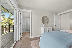 Bedroom with access to outside, baseboards, connected bathroom, and light colored carpet