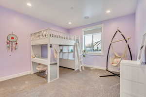 Bedroom featuring baseboards, carpet flooring, and recessed lighting