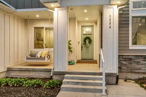 Entrance to property with stone siding and board and batten siding