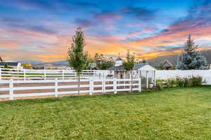 Yard at dusk featuring fence private yard and a mountain view