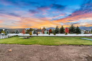 View of yard featuring a residential view, a fenced backyard, and a mountain view