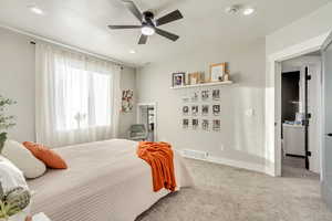 Bedroom with recessed lighting, visible vents, light carpet, and baseboards