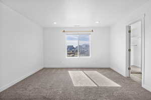 Spare room with carpet floors, baseboards, and visible vents